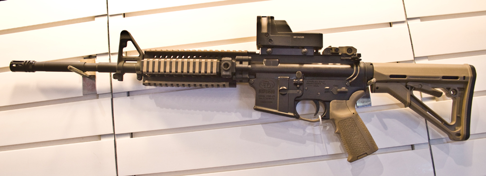 It carries a quad-rail handguard with rail covers, Magpul.
