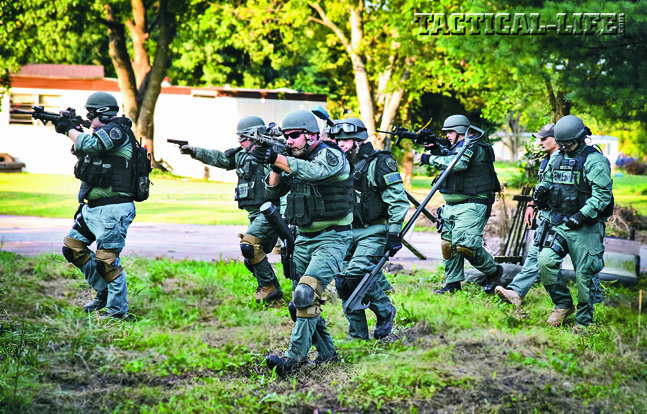 Members of the Athens County Sheriff’s Office Special Response Team practice moving into position before performing an entry into an occupied structure during training.