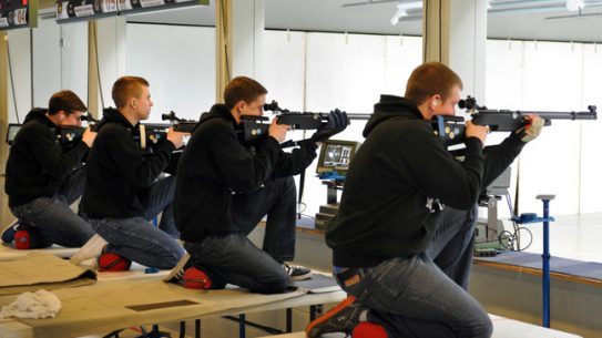 FORT BENNING, Ga. -- Members of the St. Thomas Academy, Minn. rifle team compete Feb. 26 at the 2013 U.S. Army National Junior Air Rifle Championships. Hosted by the U.S. Army Marksmanship Unit at Pool Indoor Range Complex, site of numerous World Cups, Olympic Trials and National Championships, the match brought state and individual champions to the 'Home of Champions." St. Thomas took first place overall in the sporter class division. (Photo by Michael Molinaro, USAMU)
