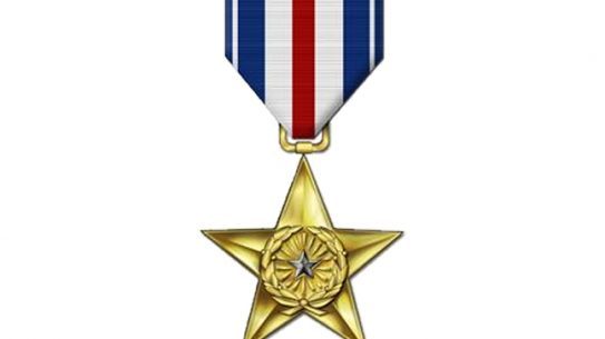 Two US soldiers have received the Silver Star for successfully defending a base in Afghanistan.