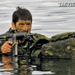 A Canadian soldier conducts a combat surface swim with his Colt Canada C8 carbine during a Patrol Pathfinder course held in Halifax, Nova Scotia.