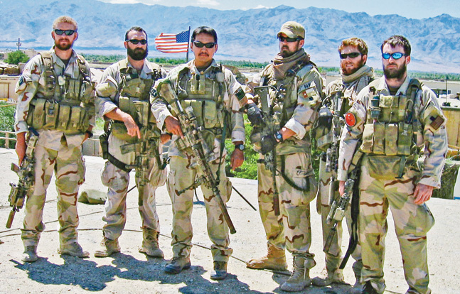 Lt. Murphy (far right) stands with his SEAL team in Afghanistan. They upheld the SEAL tradition of bravery, courage and sacrifice.