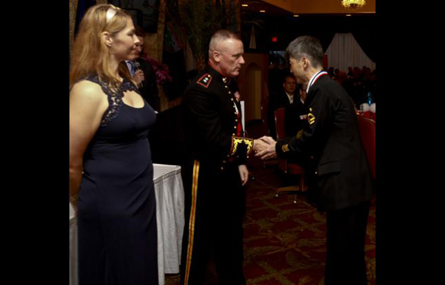 USO Okinawa Area Director, Robin Miller, left, pauses the 43rd annual USO Service Salute March 8 at the Butler Officers’ Club on Camp Foster while U.S. Marine Maj. Gen. H. Stacy Clardy III, center, congratulates Japan Maritime Self-Defense Force Petty Officer 2nd Class Nobuhiko Hyakutake. Hyakutake was among seven Japan Self-Defense Force and U.S. service members recognized for volunteer efforts and community support. Hyakutake is a network engineer with the Operations Division, Naha Communications Center, JMSDF. Clardy is the commanding general of 3rd Marine Division, III Marine Expeditionary Force.