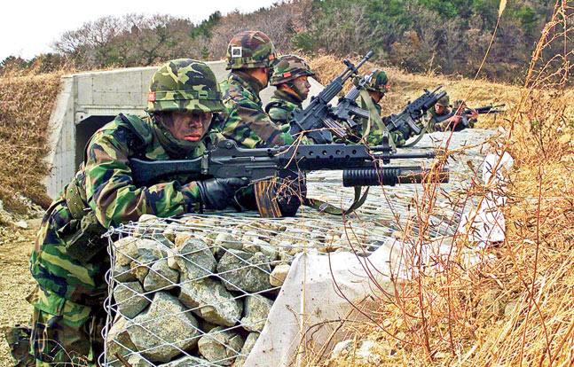 During a training exercise, ROK Marines armed with K2 rifles assume a covered position.