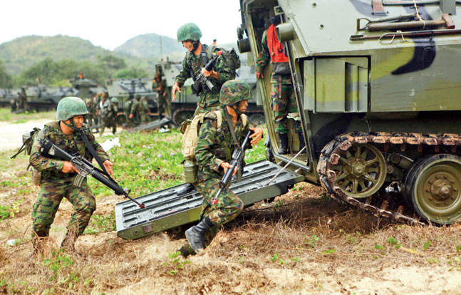 ROK Marines charge out of their assault vehicles during a training exercise in Thailand with U.S. Marines. They appear to have been loaned M16s by the U.S. troops.