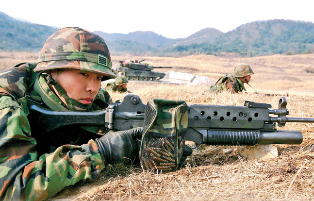 An ROK Marine armed with a K2 rifle with a 40mm grenade launcher attached. Note the brass catcher attached to the rifle.