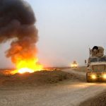A blast near a convoy shows the devastating potential of IEDs in the field. Increasingly, the U.S. armed forces have used up-armored trucks and MRAP vehicles for what used to be routine transport missions.