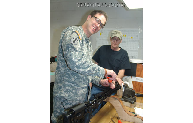 A soldier with the U.S. Army places one of the last screws to secure the monolithic rail on the very last M2010.