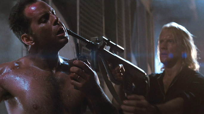 Karl points his Steyr AUG at John McClane in Die Hard