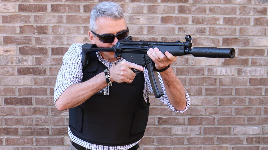 The author wears the vest while shouldering an MP5.